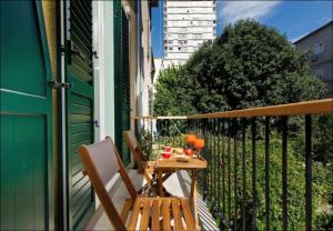 a table and chairs sitting on a balcony at Sailor Boutique Rooms in Split
