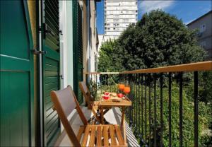 a table and chairs on the balcony of a house at Sailor Boutique Rooms in Split +21 photos