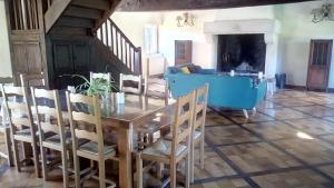a dining room with a table and chairs at Domaine de Gentilly in Saint-Maurice-lès-Charencey