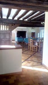 a large living room with a table and chairs at Domaine de Gentilly in Saint-Maurice-lès-Charencey