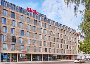 a large brick building with a sign on it at aletto Hotel Potsdamer Platz in Berlin