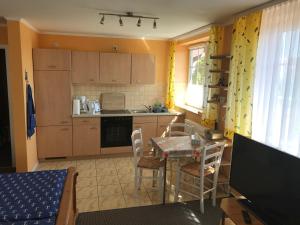 a kitchen with a table and a table and chairs at Residenz am Peeneplatz in Peenemünde