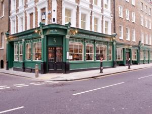 a green building on the side of a street at Montcalm Brewery Townhouse in London