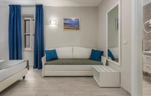 a living room with a couch and blue curtains at Boutique Hotel Melissa in Poreč