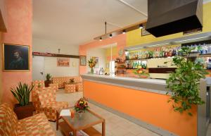 チェゼナーティコにあるHotel Acaciaのカウチ付きのバーのあるレストラン