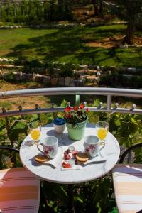 a white table with sandwiches and glasses of orange juice at Apartments Vinka in Sveti Filip i Jakov