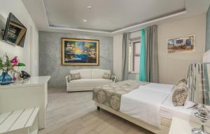 a bedroom with a white bed and a couch at Boutique Hotel Melissa in Poreč +34 photos