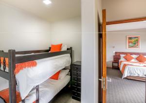 a bedroom with two bunk beds and a mirror at Rio Vista Lodge in Malelane