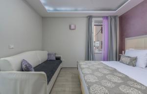 a hotel room with two beds and a couch at Boutique Hotel Melissa in Poreč