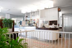 a lobby with a counter and a bar at Hotel San Pietro in Cervia