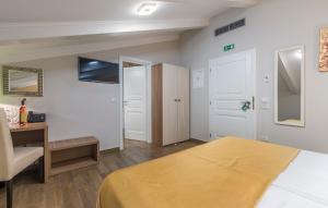 a hotel room with a bed and a desk and a desk at Boutique Hotel Melissa in Poreč
