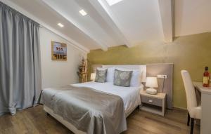 a bedroom with a white bed and a table and a window at Boutique Hotel Melissa in Poreč
