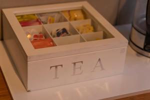 a white box with the word tea on it at Platypus Waters B&B in Smithton