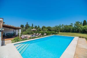 a swimming pool in the backyard of a house at Ferragut in Pollença