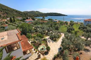 an aerial view of a house and the ocean at Niki Apartments in Panormos Skopelos