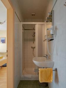 a bathroom with a sink and a shower at Gasthof Familie Hutter in Rattersdorf