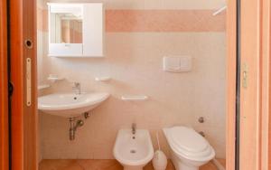 a bathroom with a toilet and a sink at Villa la Mezza Luna in Torre Santa Sabina +33 photos