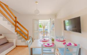 a dining room with a white table and chairs at Villa la Mezza Luna in Torre Santa Sabina