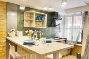 a kitchen with a table with blue dishes on it at STUDIO APARTMAN ELEVEN in Rovinj