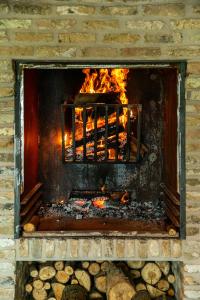 a brick fireplace with a fire in it at 't Goed ter Fintele in Lo-Reninge