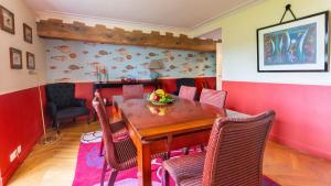 a dining room with a wooden table and chairs at Le Clos Tellier in Mareil-Marly