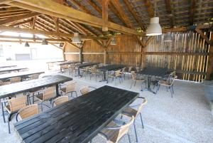 a group of tables and chairs in a barn at Banja Kulaši in Kulaši