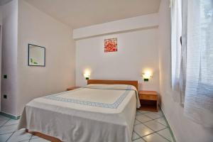 A bed or beds in a room at L'Oasi di Ottiolu