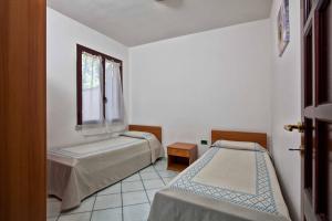 A bed or beds in a room at L'Oasi di Ottiolu