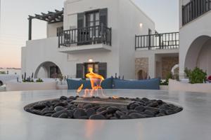 a fire pit in the middle of a patio at Parian Boutique Hotel in Naousa