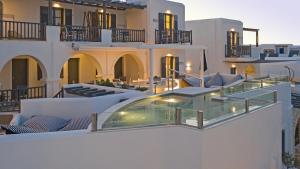 a balcony of a building with chairs and tables at Parian Boutique Hotel in Naousa