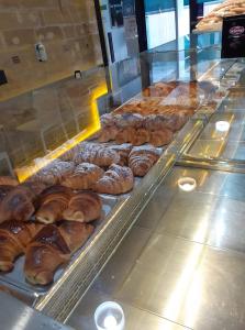 a display case in a bakery with lots of pastries at B&B Porticella in Marsala