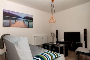 a living room with a couch and a tv at Ferienwohnung Zschopau für Sie vollausgestattet mit Boxspringbett Netflix uvm in Zschopau