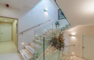 a staircase in a house with a glass railing at Boutique Hotel Melissa in Poreč