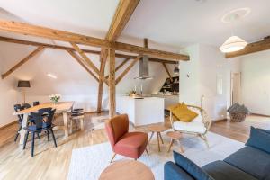a living room and kitchen with wooden beams at Traum-ferienwohnung in Siegsdorf