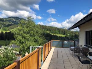 a balcony with tables and chairs and a view of a mountain at Haus W5 - DorfResort Mitterbach in Mitterbach