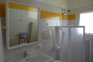 a bathroom with a sink and a mirror and a shower at Ostello Torino in Turin +49 photos