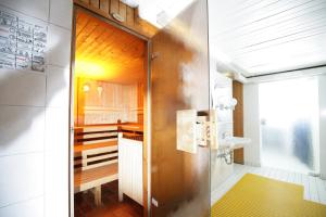 a kitchen with a stainless steel door and a sink at Apartment Hohenstaufen in Göppingen +34 photos