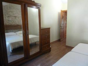 A bed or beds in a room at Os NOVOS