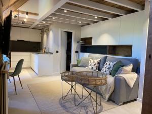 a living room with a couch and a table at Bonito dúplex en Vielha in Vielha