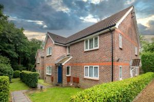 a brick house with a blue door at Sublime Stays Thornhill 1 Bed Apartment Crawley in Crawley