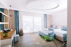 a living room with a bed and a couch at Ilica Hotel Spa & Wellness Resort in Çeşme