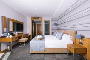 a hotel room with a bed and a desk at Ilica Hotel Spa & Wellness Resort in Çeşme