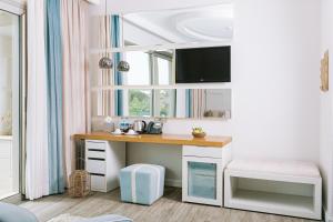 a desk in a room with a window at Ilica Hotel Spa & Wellness Resort in Çeşme