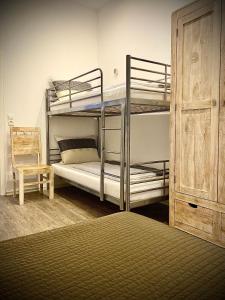 a bedroom with two bunk beds and a chair at Dilger Apartments in Rust