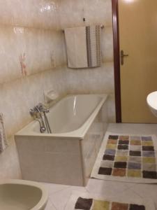 a bathroom with a tub and a toilet and a sink at B&B THE BIKERS in Guspini
