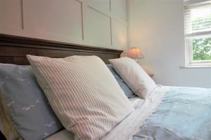 a bedroom with a bed with two pillows on it at Brookfields in Wadebridge