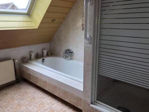 baño grande con bañera y ventana en La Casa aan Zee, en Ellemeet