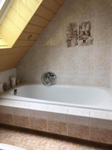 a large white bath tub in a room at La Casa aan Zee in Ellemeet