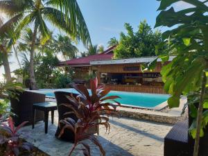 a resort with a swimming pool and a restaurant at Apo Diver Beach Resort in San Juan