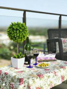 a table with a bottle of wine and two glasses at Villa Don Pedro in Gran Alacant
